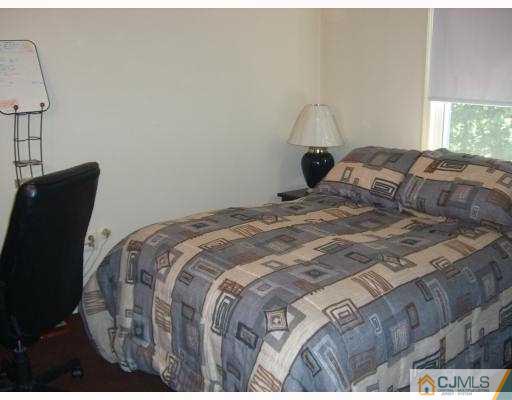 33 Meredith Road Piscataway, NJ 08854 - Photo 8 of 8 a bedroom with a bed and window