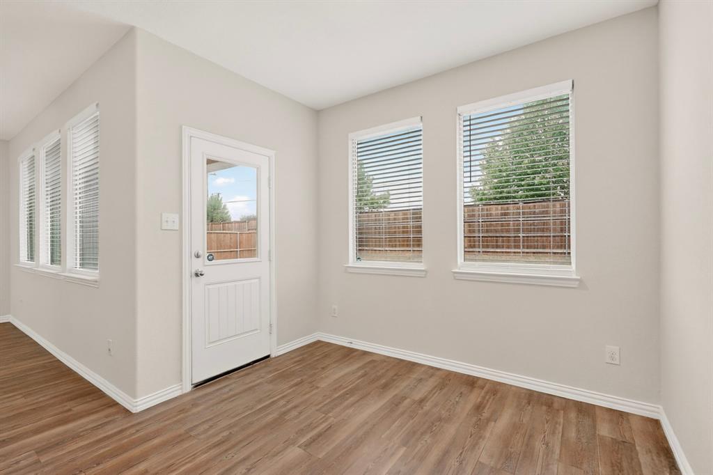 3321 Riverside Drive Aubrey, TX 76227 - Photo 15 of 40 a view of an empty room with wooden floor and a window