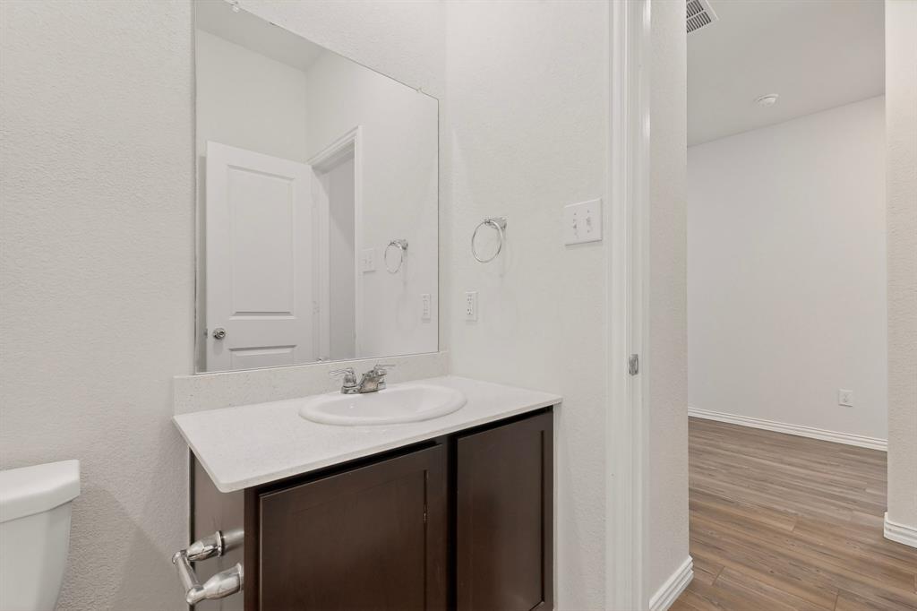 3321 Riverside Drive Aubrey, TX 76227 - Photo 17 of 40 a bathroom with a sink and a mirror