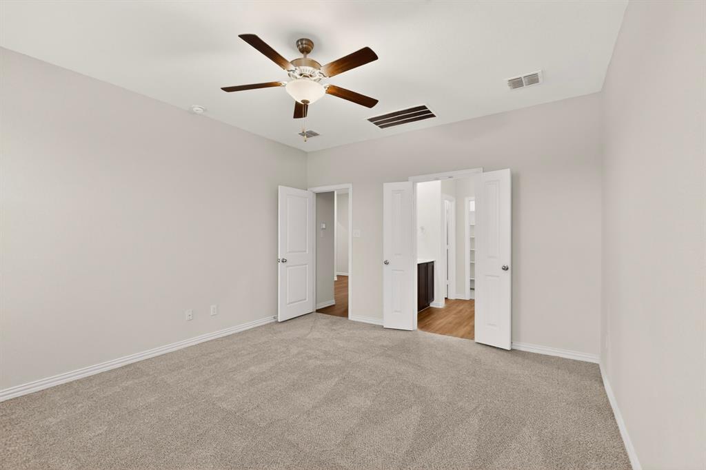 3321 Riverside Drive Aubrey, TX 76227 - Photo 21 of 40 an empty room with closet and a ceiling fan