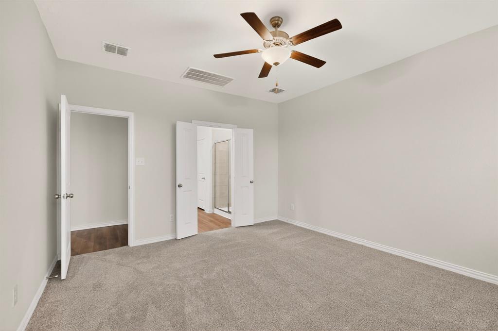 3321 Riverside Drive Aubrey, TX 76227 - Photo 22 of 40 an empty room with a ceiling fan and a window