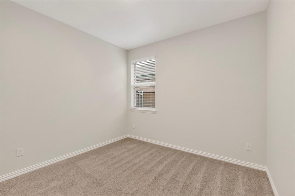 3321 Riverside Drive Aubrey, TX 76227 - Photo 27 of 40 a view of an empty room with wooden floor and a window