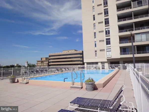 a view of roof deck with outdoor seating and city view