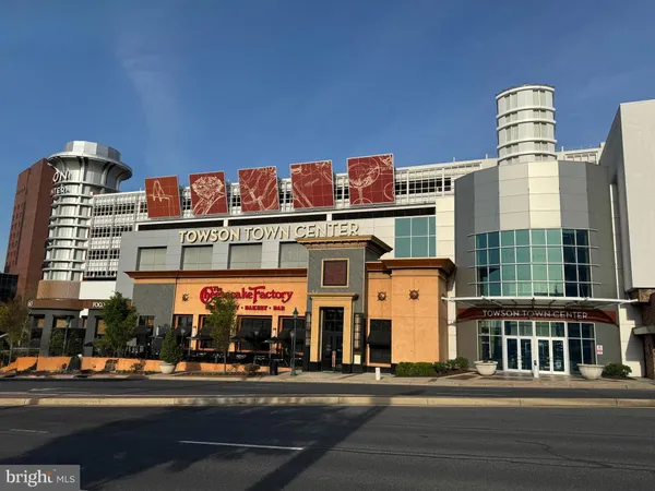 a front view of multi story building with retail shops