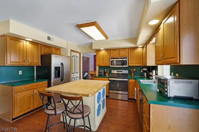 a kitchen with stainless steel appliances a stove a sink dishwasher and a refrigerator