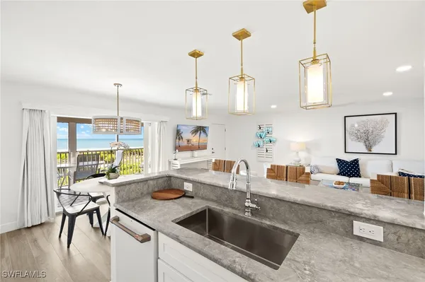 a kitchen with stainless steel appliances granite countertop a stove and a wooden floors
