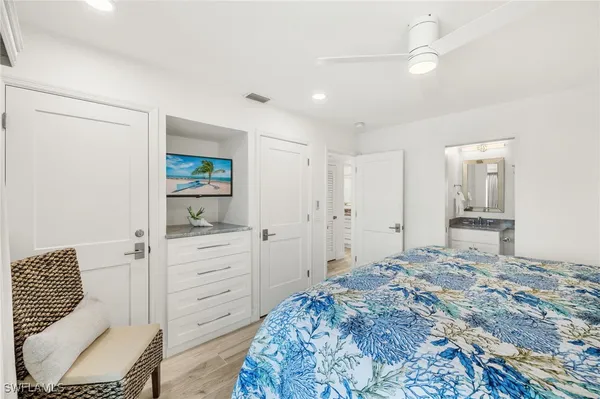 a bedroom with a bed and a lamp