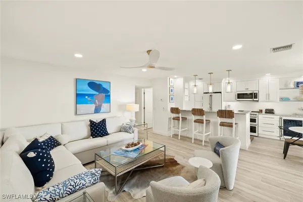 a living room with furniture and a wooden floor