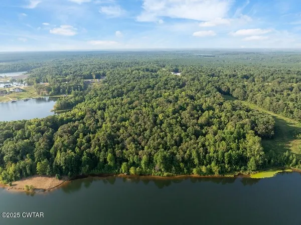 a view of a lake with a yard