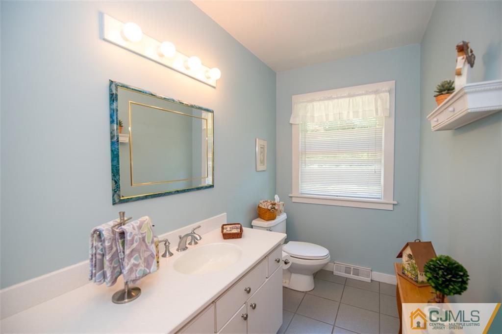 91 Conover Road West Windsor, NJ 08550 - Photo 12 of 25 a bathroom with a sink a toilet and mirror