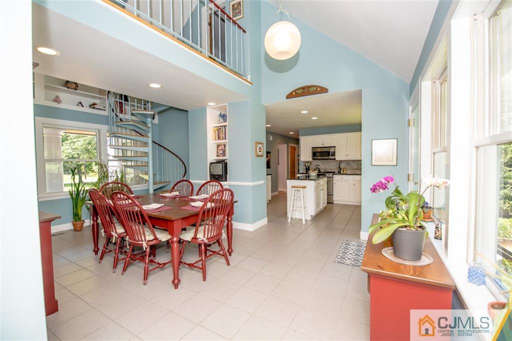 91 Conover Road West Windsor, NJ 08550 - Photo 7 of 25 a view of a dining room with furniture and floor to ceiling window