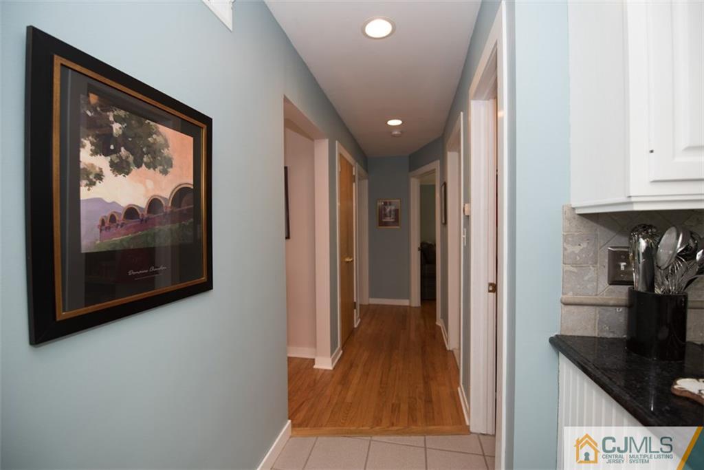 91 Conover Road West Windsor, NJ 08550 - Photo 10 of 25 a view of a hallway with wooden floor and a living room