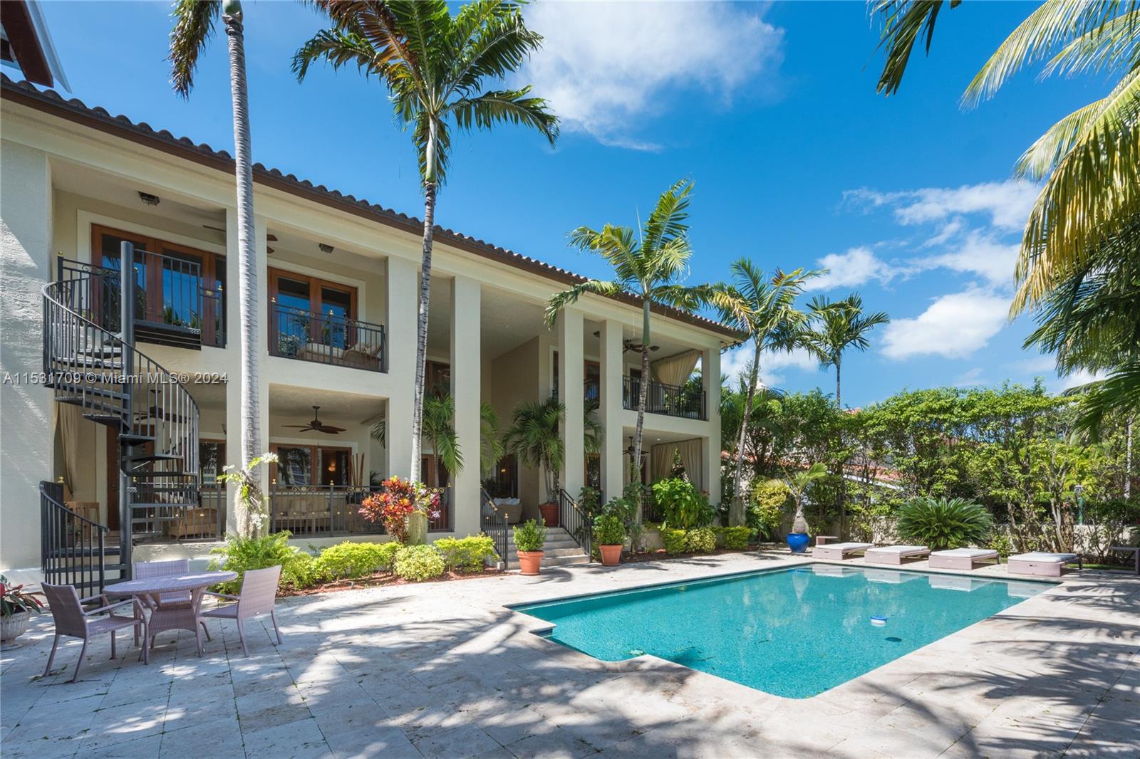5655 Pine Tree Drive Miami Beach, FL 33140 - Photo 11 of 21 a view of a patio with swimming pool table and chairs