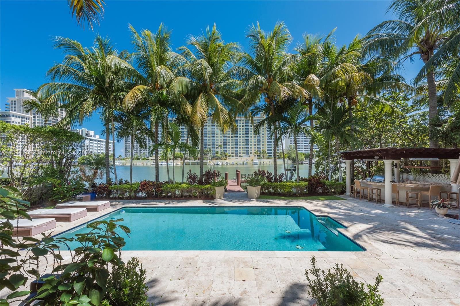 5655 Pine Tree Drive Miami Beach, FL 33140 - Photo 12 of 21 a view of a yard with palm trees
