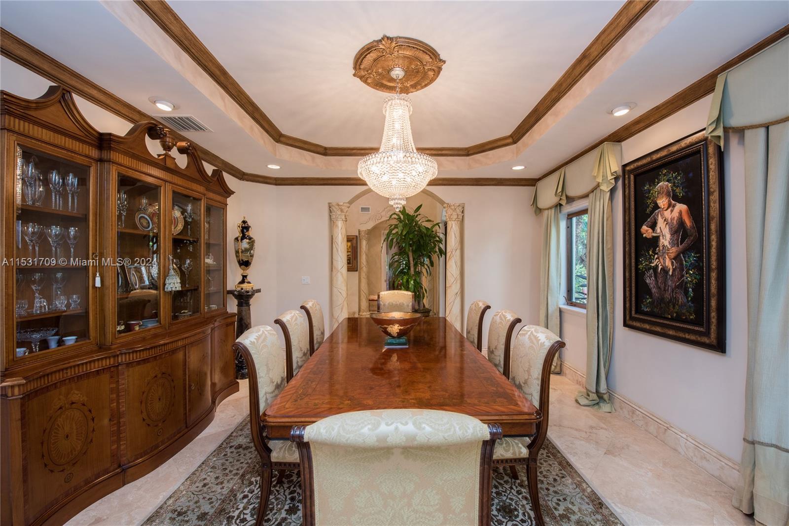 5655 Pine Tree Drive Miami Beach, FL 33140 - Photo 3 of 21 a dining room with furniture and a chandelier