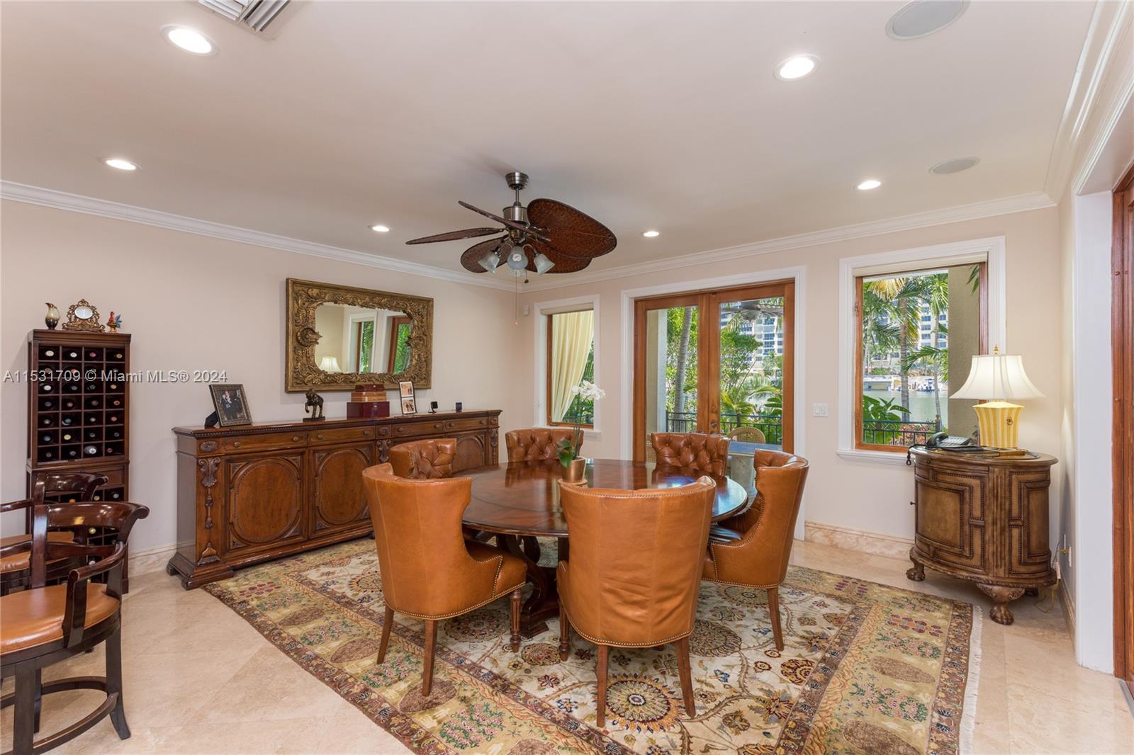 5655 Pine Tree Drive Miami Beach, FL 33140 - Photo 7 of 21 a dining room with furniture a window and wooden floor
