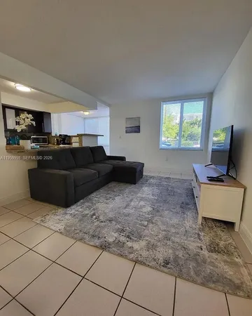 a living room with furniture window and a flat screen tv