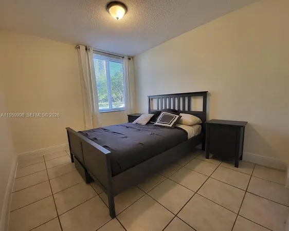 a bed sitting in a room next to a window