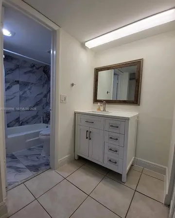 a bathroom with a granite countertop sink a vanity and a mirror