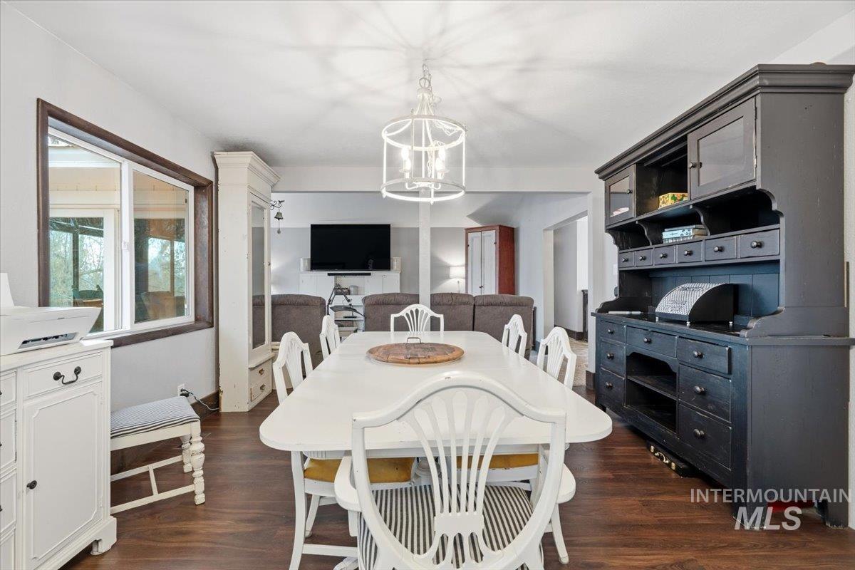 7771 Elmore Road Fruitland, ID 83619 - Photo 7 of 48 Dining room featuring dark wood-style flooring and suspended lighting