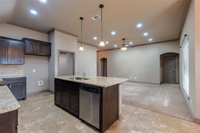 a kitchen with a stove a refrigerator and a sink