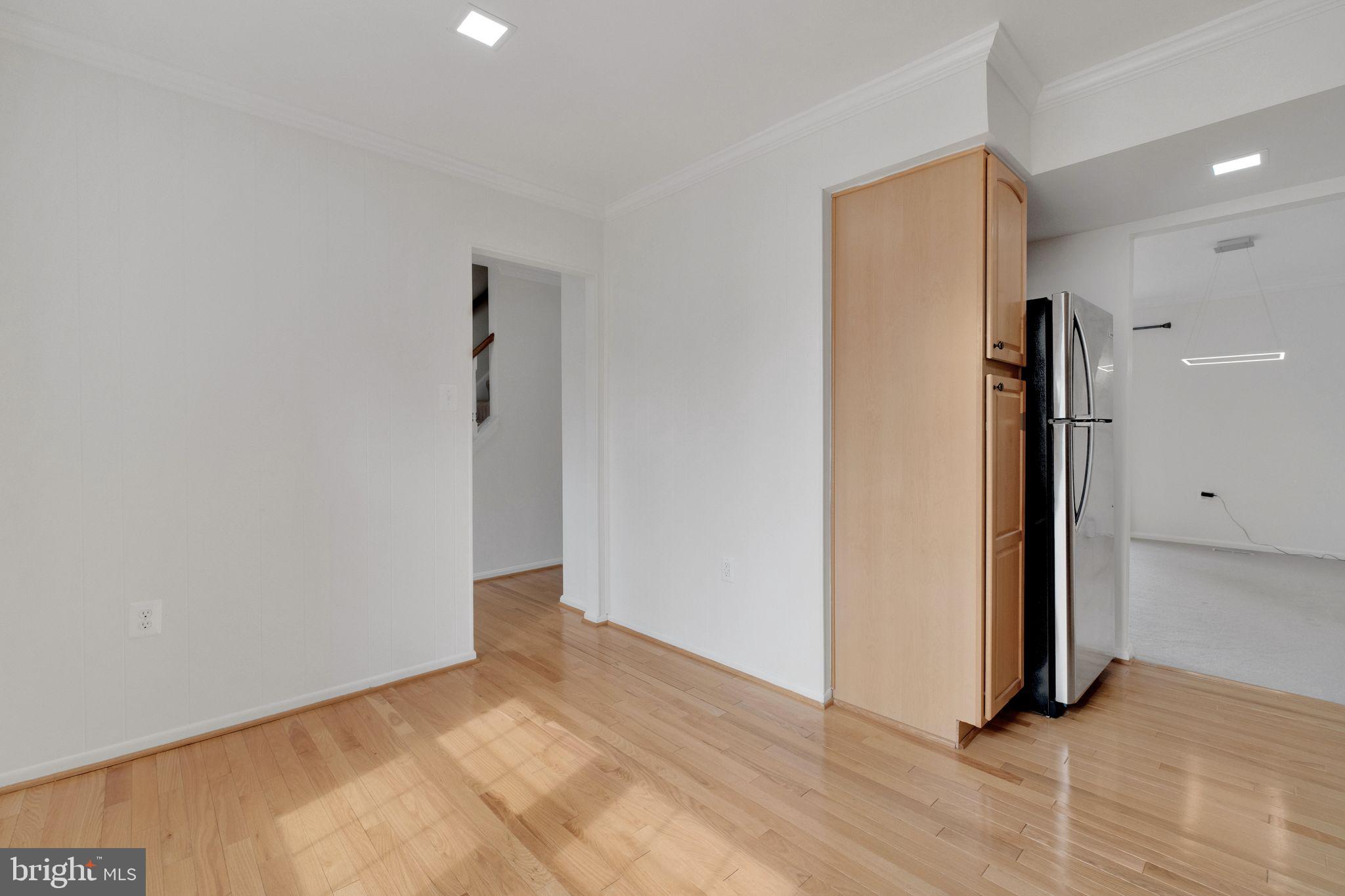6002 Mardale Lane Burke, VA 22015 - Photo 11 of 28 a view of a hallway with wooden floor and a cabinet