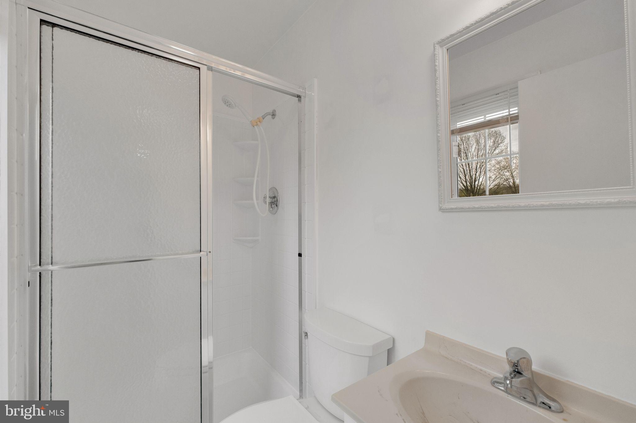 6002 Mardale Lane Burke, VA 22015 - Photo 15 of 28 a bathroom with a shower and a sink