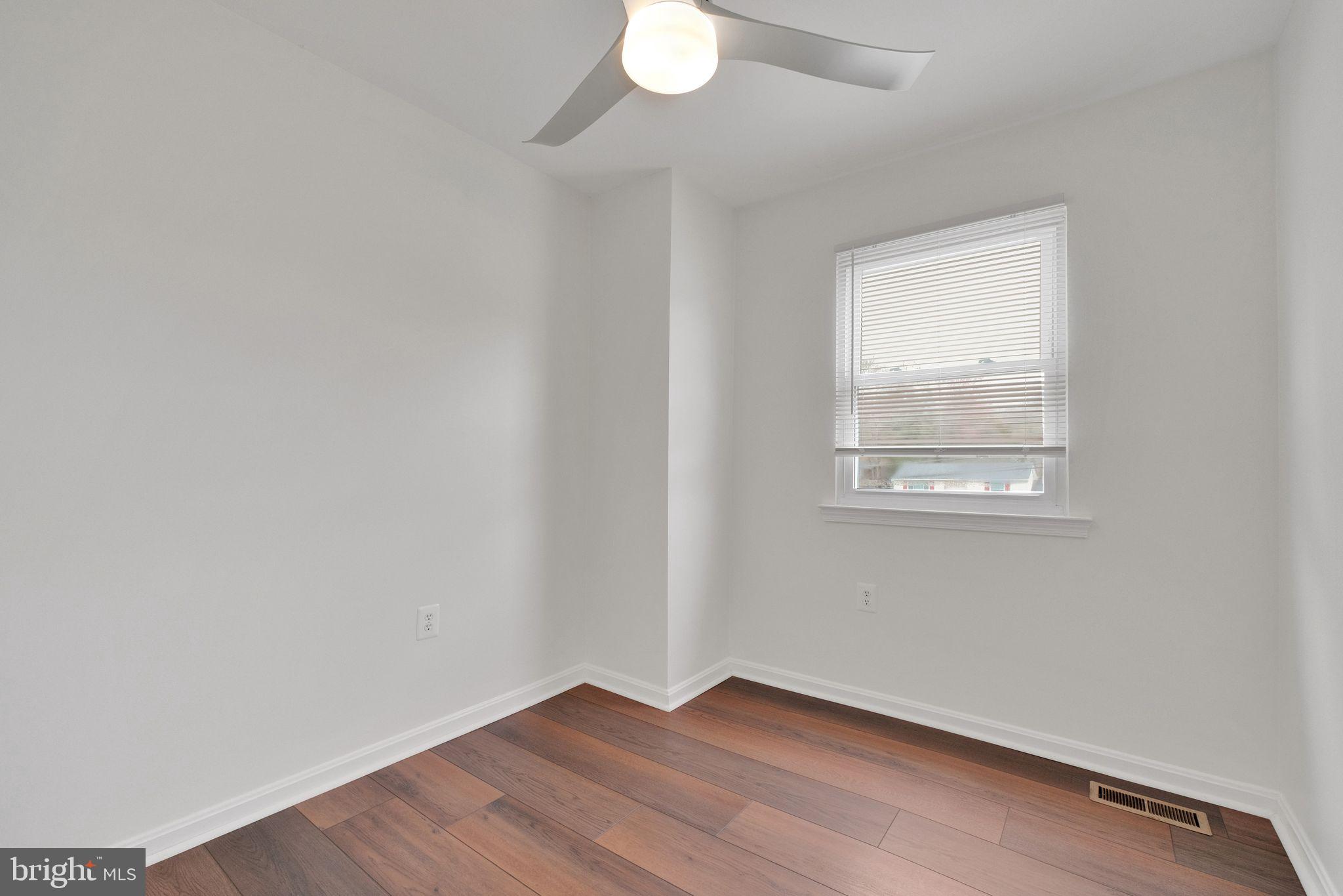 6002 Mardale Lane Burke, VA 22015 - Photo 19 of 28 an empty room with wooden floor and windows