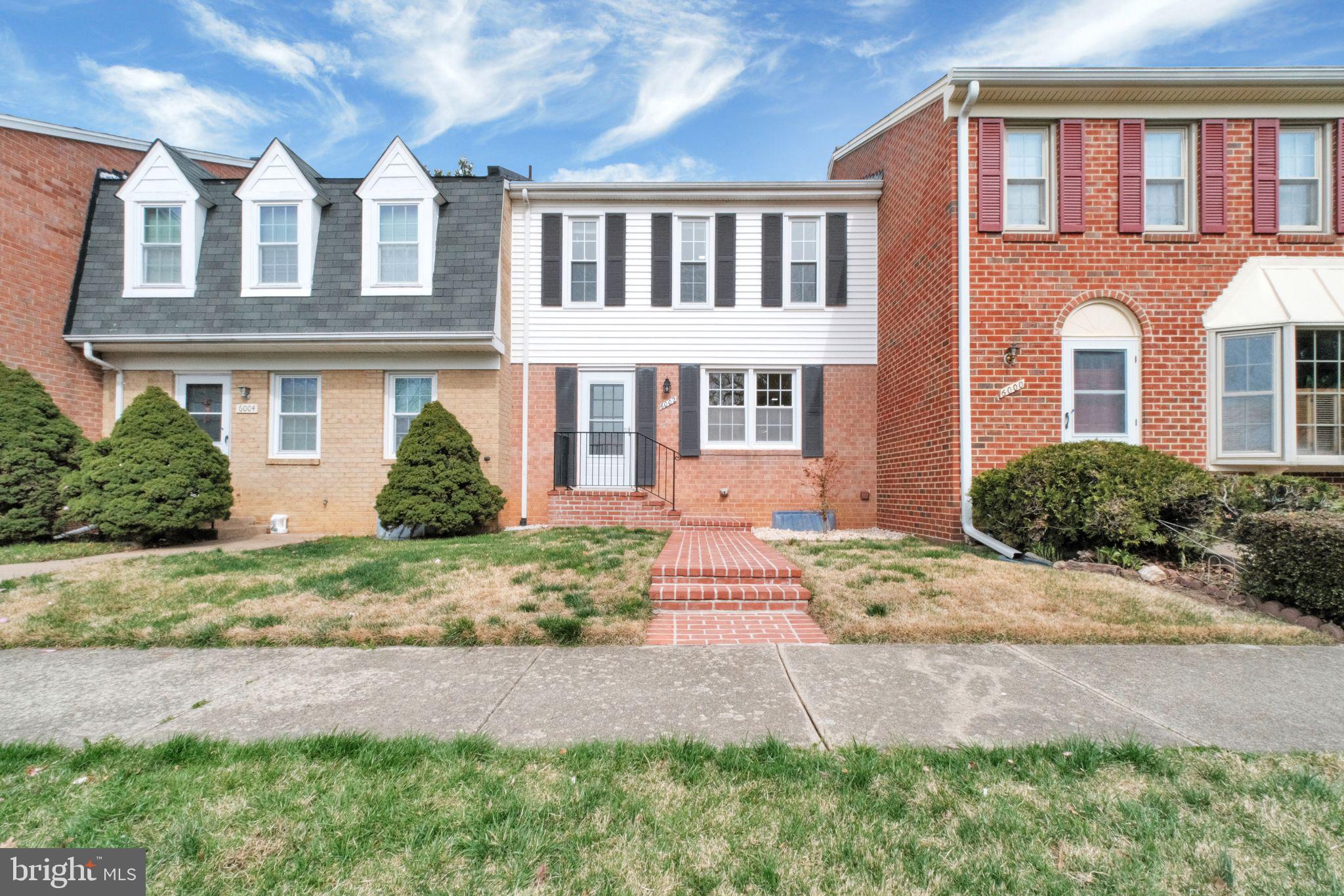 6002 Mardale Lane Burke, VA 22015 - Photo 2 of 28 a front view of a house with a yard and potted plants