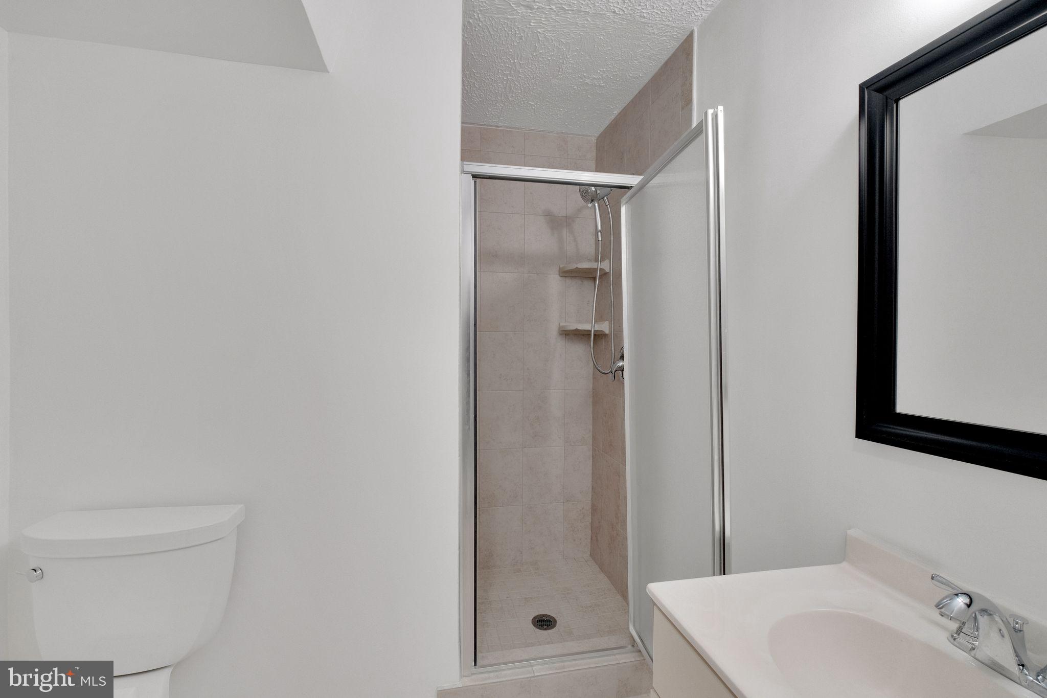 6002 Mardale Lane Burke, VA 22015 - Photo 25 of 28 a bathroom with a shower and a sink