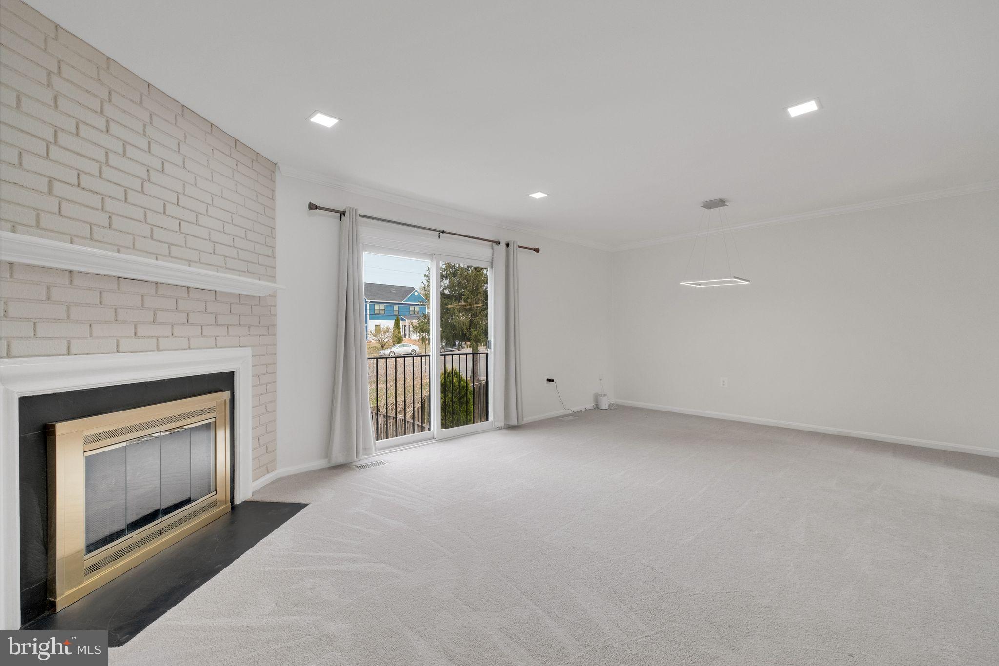 6002 Mardale Lane Burke, VA 22015 - Photo 4 of 28 a view of an empty room with a fireplace