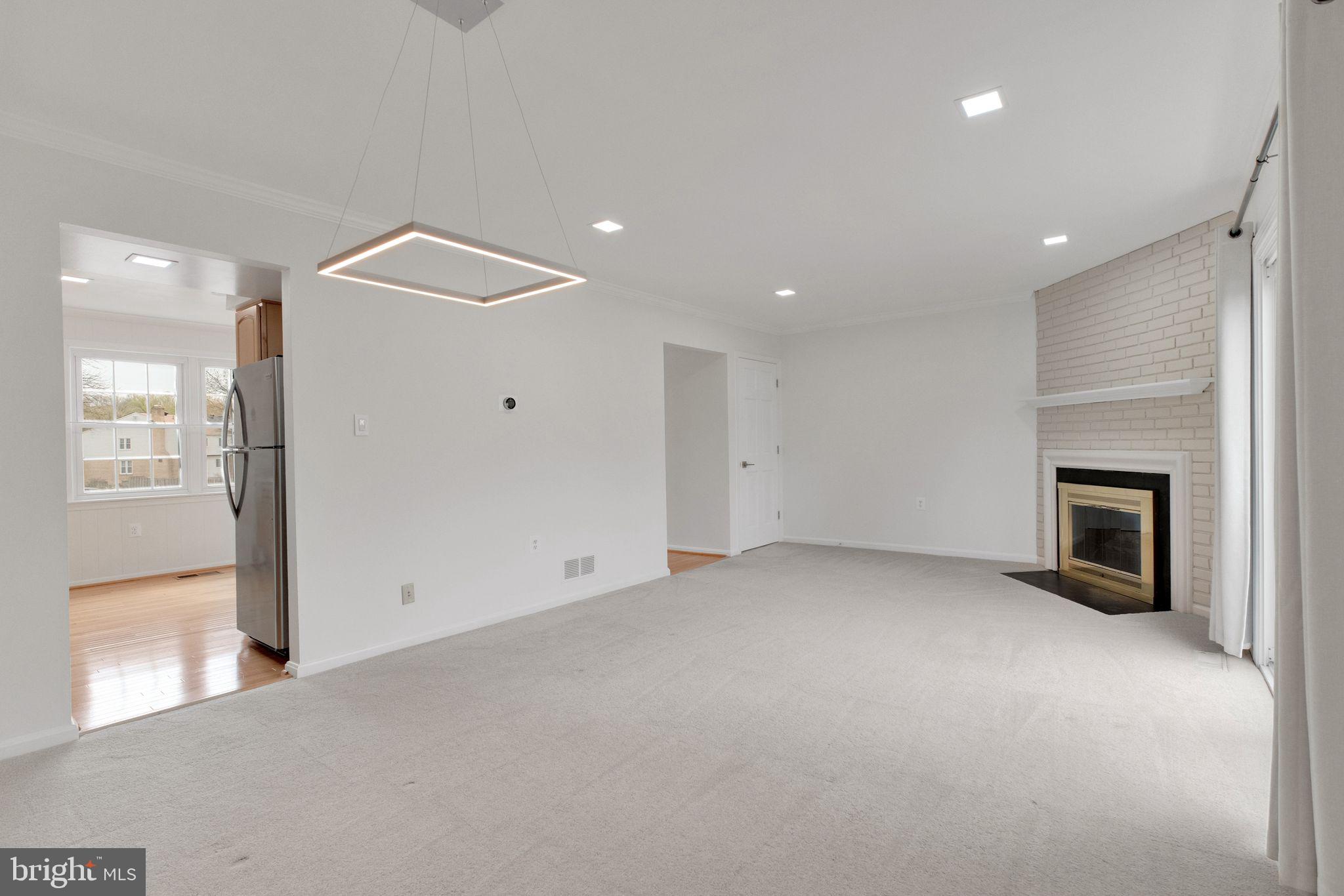 6002 Mardale Lane Burke, VA 22015 - Photo 6 of 28 a view of empty room with wooden floor and fireplace