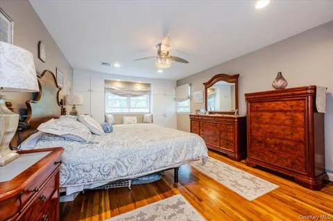a spacious bedroom with a bed and a chandelier