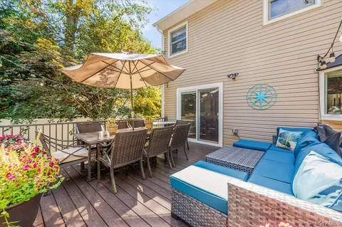 an outdoor sitting area with furniture and wooden deck