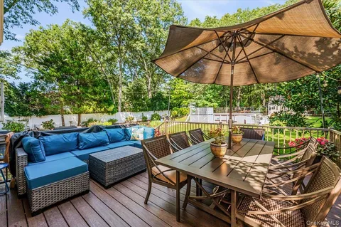 a view of a chairs and table in backyard of the house
