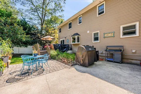 a view of a backyard with sitting area and garden