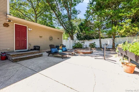 a view of a patio with table and chairs and potted plants