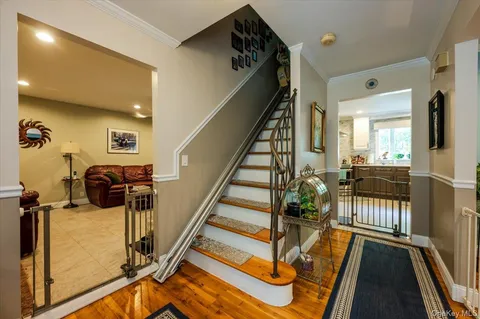 a view of a hallway with wooden floor and staircase