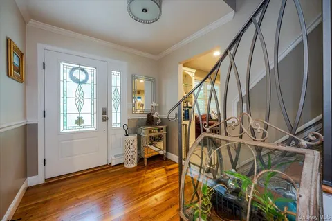 a view of an entryway with wooden floor and door