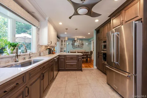 a large kitchen with a large counter top appliances and cabinets