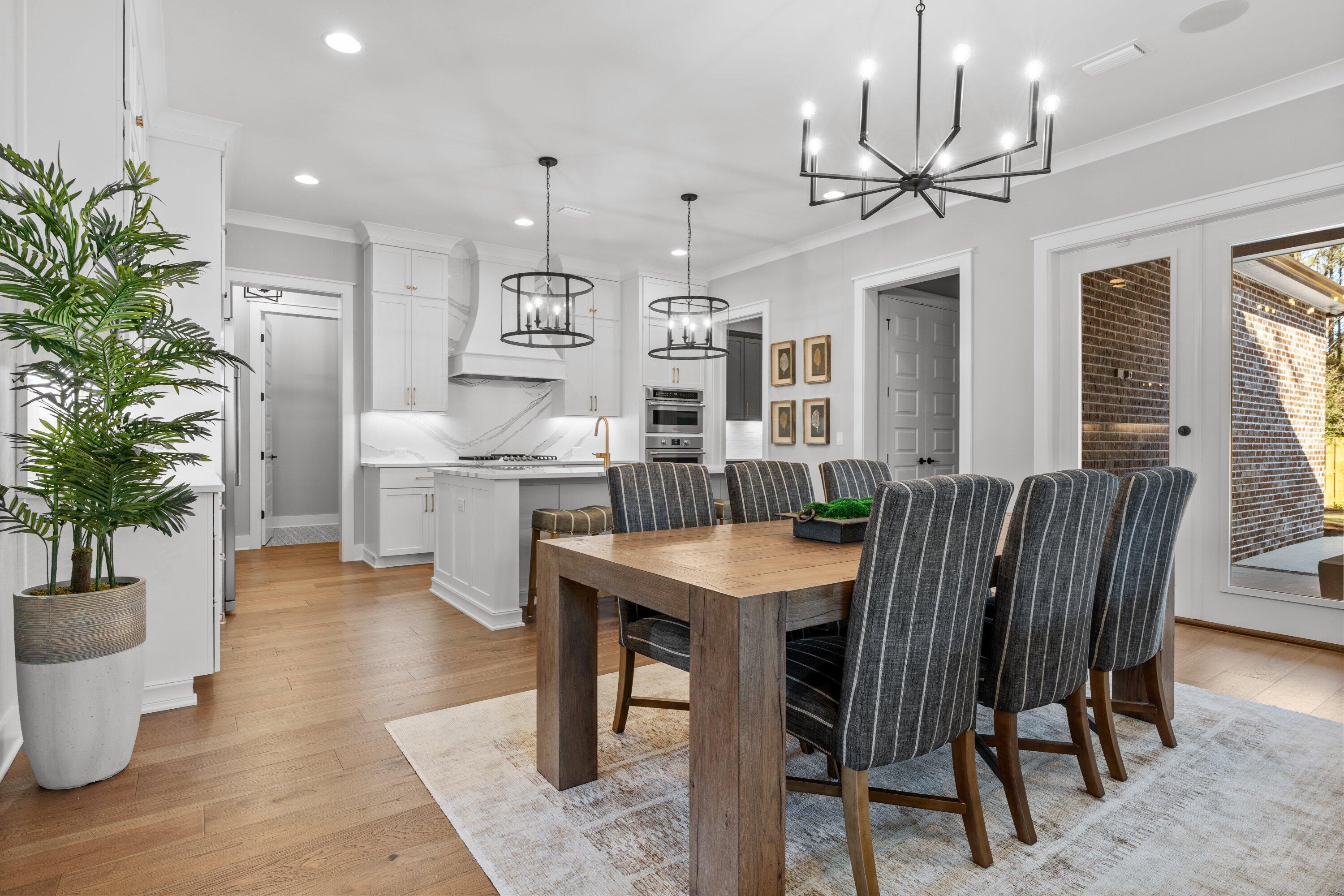 471 Shimmer Circle Freeport, FL 32439 - Photo 16 of 46 a view of a dining room with furniture window and wooden floor