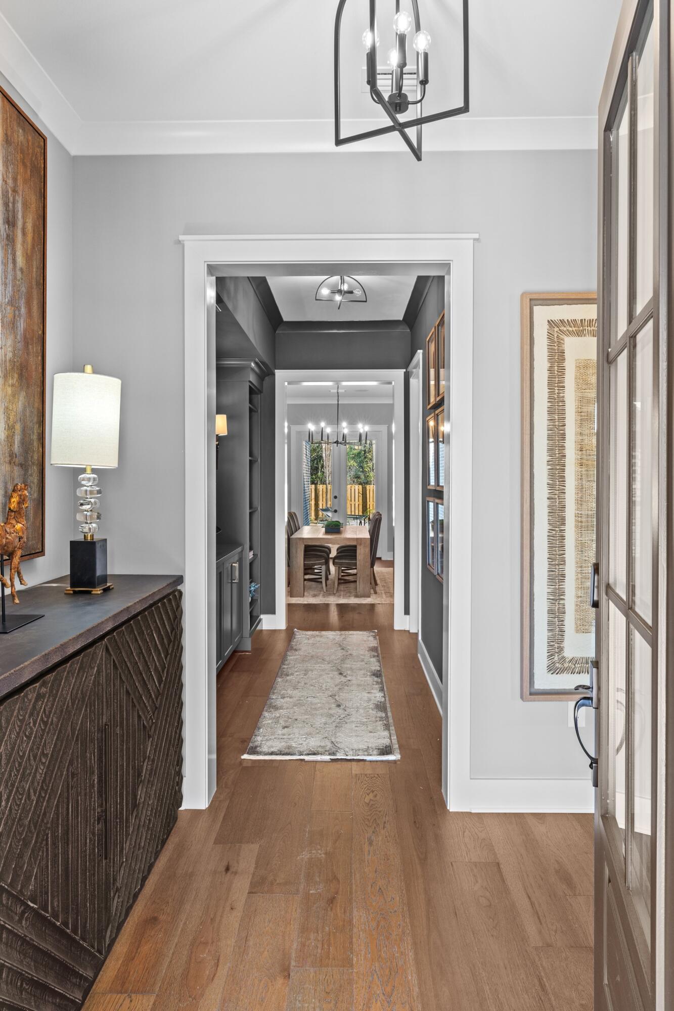 471 Shimmer Circle Freeport, FL 32439 - Photo 3 of 46 a view of a hallway view with living room and wooden floor