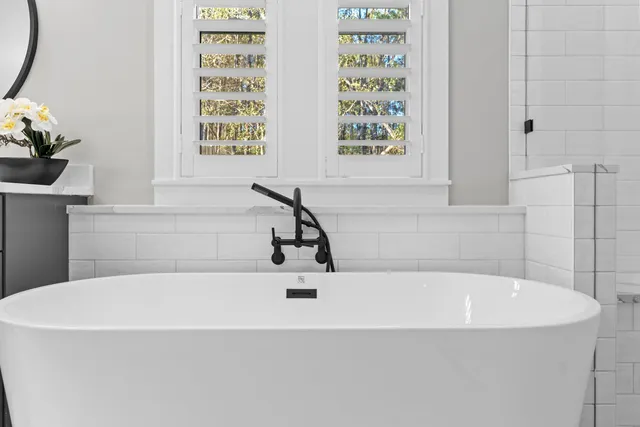 a white bath tub sitting next to a window