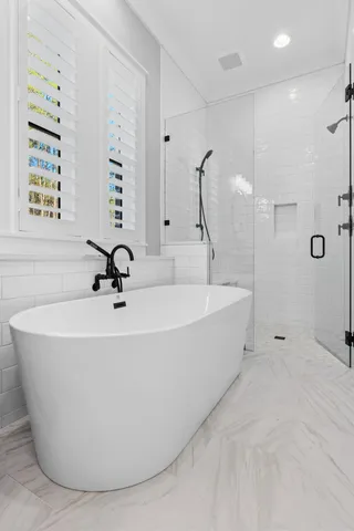 a white bath tub sitting in a bathroom
