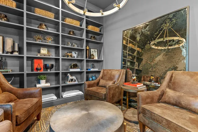 a living room with furniture and a book shelf