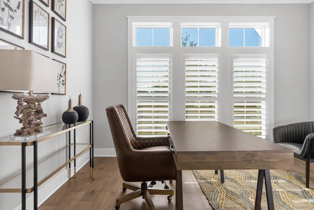 a view of a workspace with furniture and a window