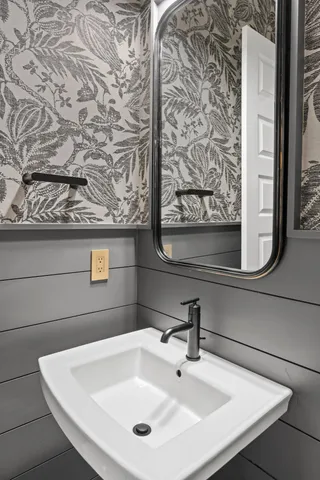 a bathroom with a sink and mirror