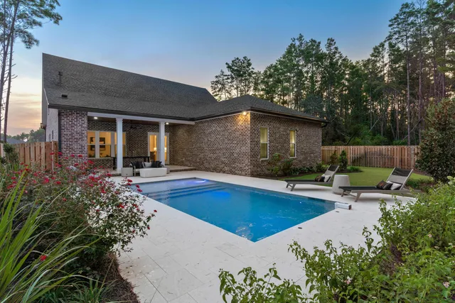 a view of swimming pool with outdoor seating and plants