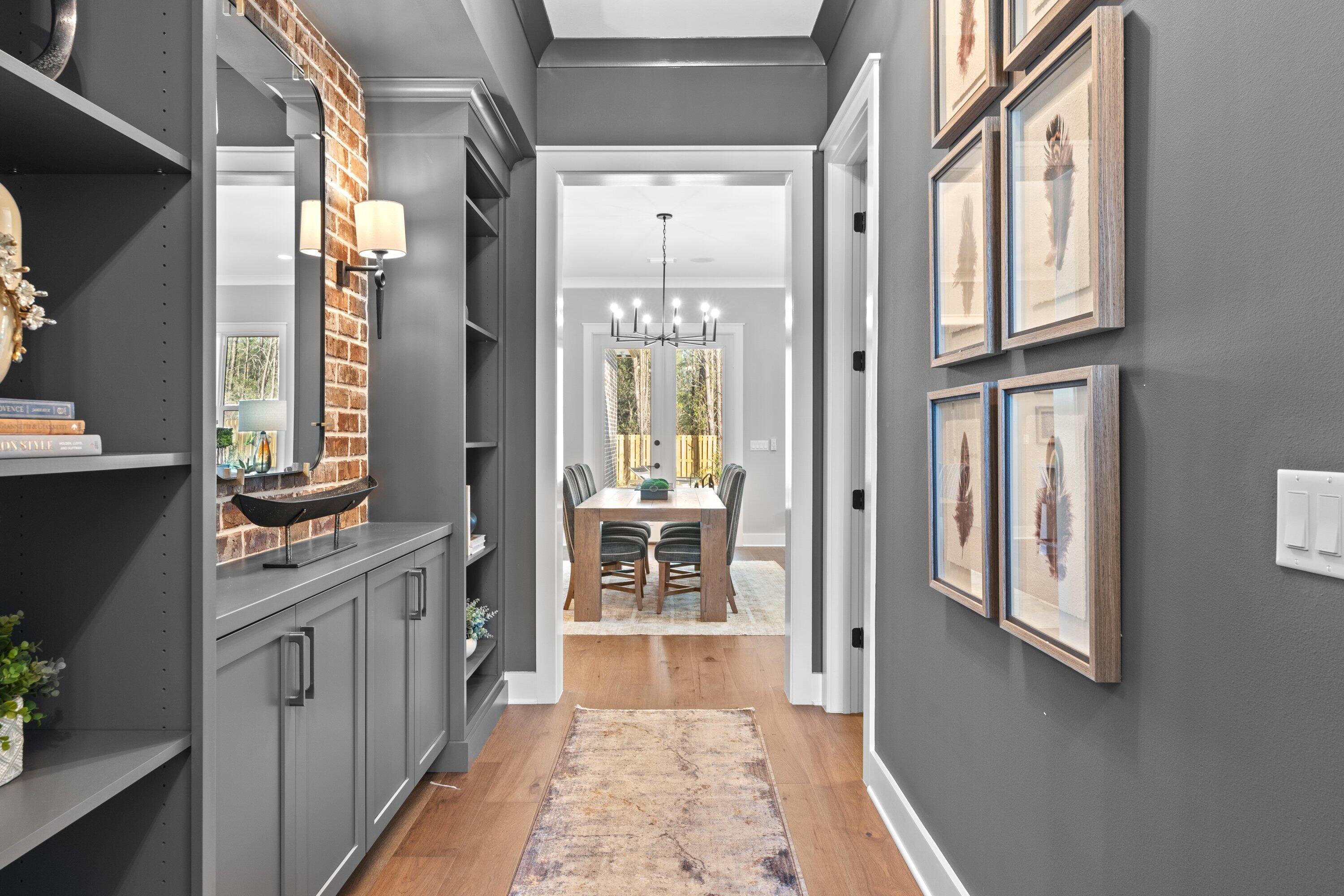 471 Shimmer Circle Freeport, FL 32439 - Photo 5 of 46 a hallway with windows and chandelier