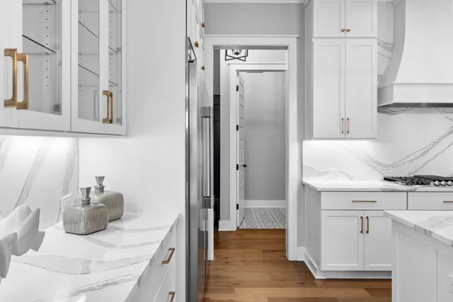 a kitchen with stainless steel appliances granite countertop a sink and wooden cabinets
